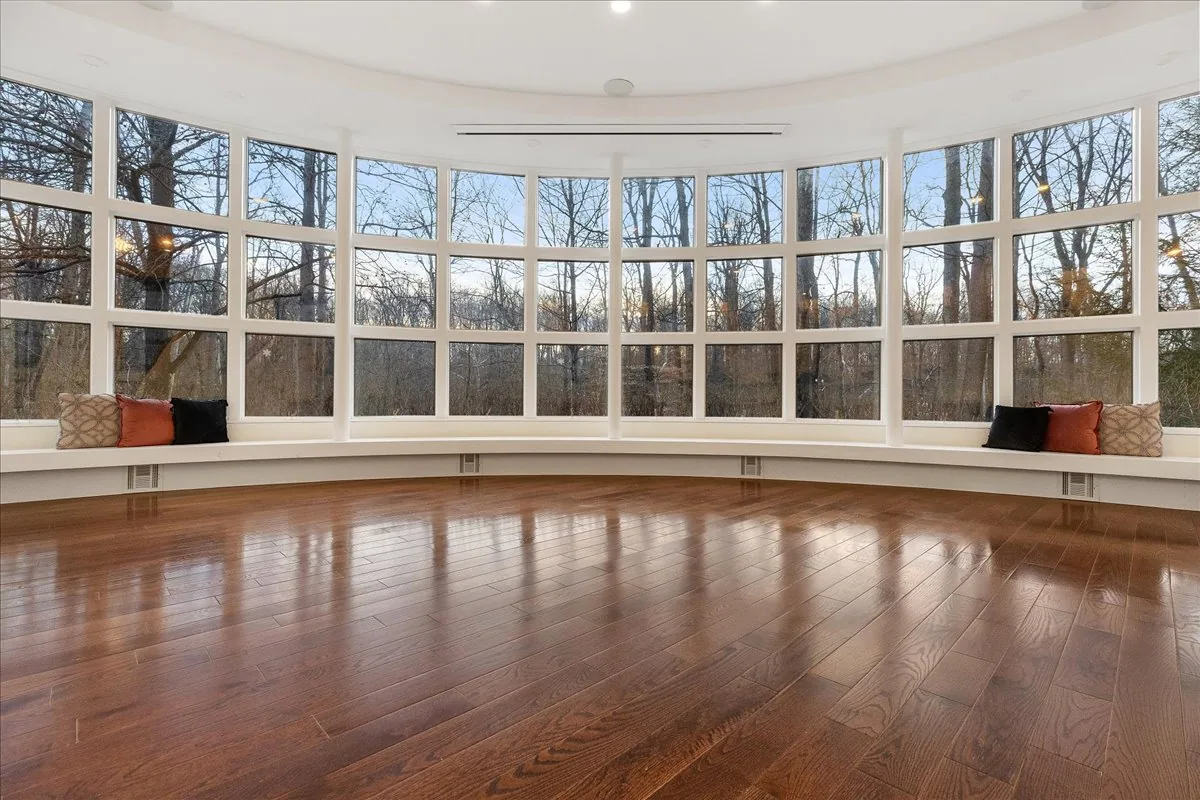 Curved glass great room with Stony Brook views