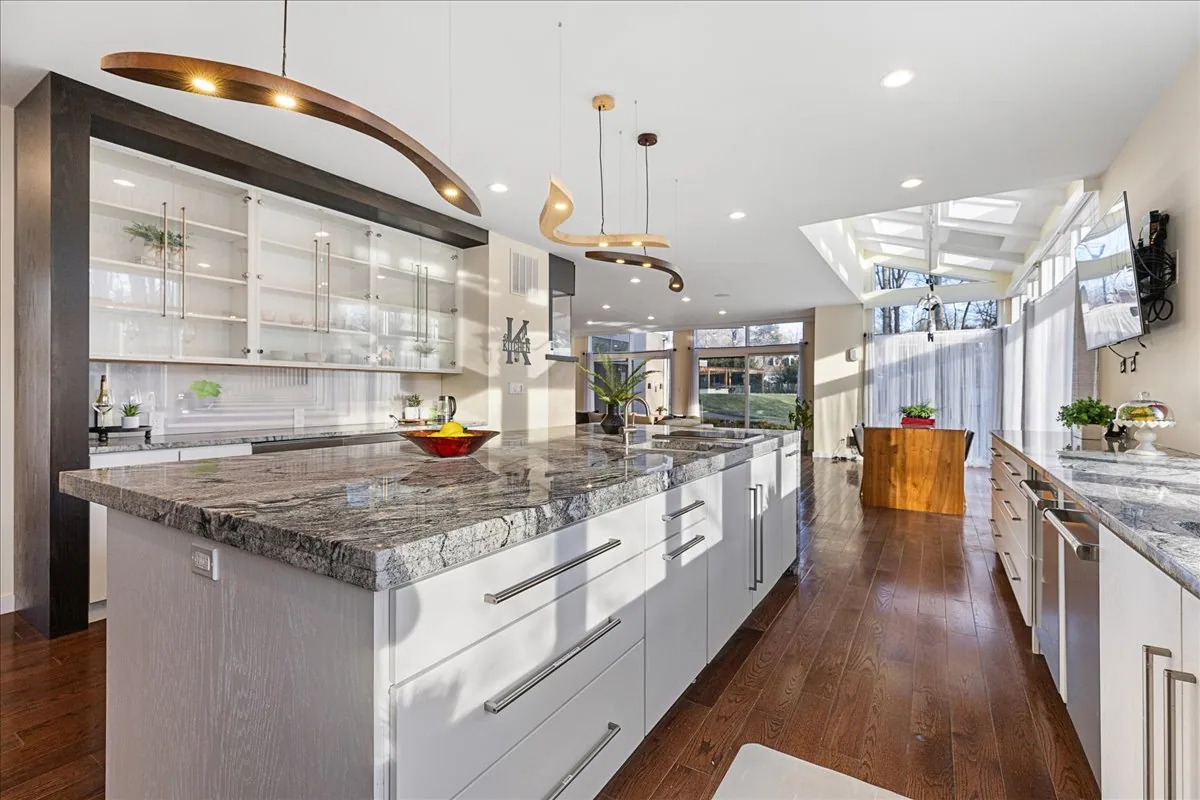 Chef's kitchen with waterfall granite island
