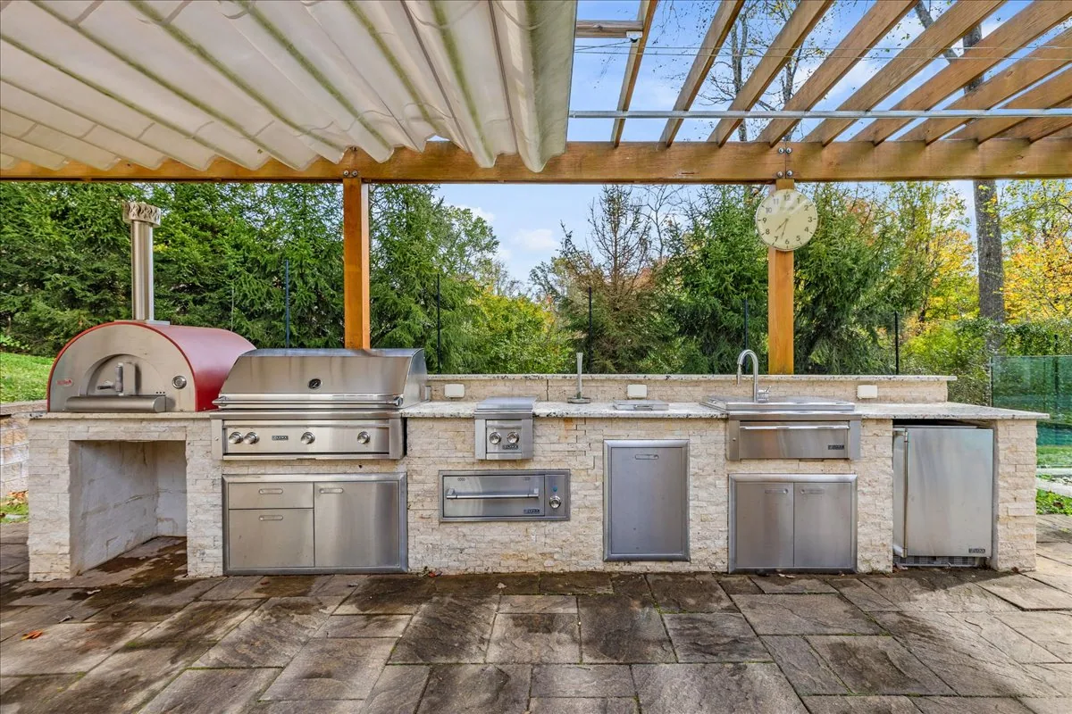 Outdoor kitchen with pizza oven and grill